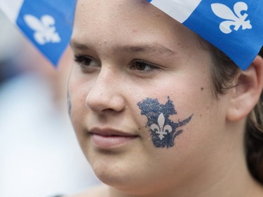 A young girl attends a Fête nationale celebration in a town west of Montreal, Sunday, June 24, 2018.