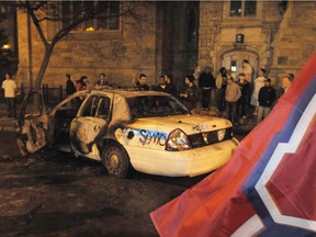 A burned out police cruiser sits in Downtown Montreal as violence erupted following the Montreal Canadiens' elimination of the Boston Bruins in game 7 of the first round of Stanley Cup playoffs in Montreal, Monday, April 21, 2008. The Supreme Court of Canada has ruled against the City of Montreal in a case involving rioters who damaged police vehicles after a 2008 Montreal Canadiens victory.