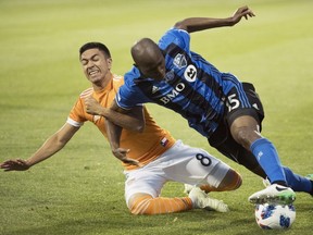 Houston Dynamo's Memo Rodriguez (8) challenges Montreal Impact's Rod Fanni during second half MLS soccer action in Montreal on Saturday, June 2, 2018.