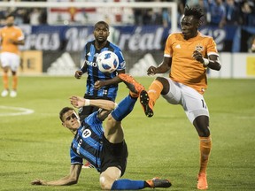 Houston Dynamo's Alberth Elis, right, challenges Montreal Impact's Jukka Raitala during second half MLS soccer action in Montreal on June 2, 2018. Raitala will miss Saturday's game in Dallas because he has been called up by the Finnish national team for a friendly against Belarus.