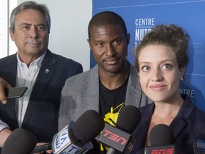 Montreal Impact executive vice-president Richard Legendre, left, former Canadian international player as well as ambassador for the United 2026 bid Patrice Bernier and Montreal city councillor Rosannie Filato, right, speak to the media after the successful bid and awarding of the 2026 FIFA World Cup to Canada, Mexico and the United States, Wednesday, June 13, 2018 in Montreal.
