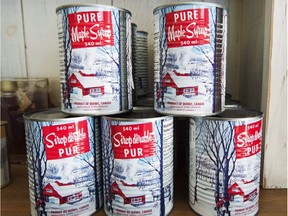 Maple syrup cans are seen at a sugar shack, Friday, February 10, 2017 in Oka, Quebec. The Federation of Quebec Maple Syrup Producers says it plans to tap into its strategic reserves after a cold spring led to a drop in production.