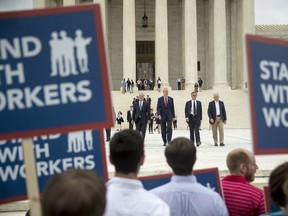 From left, Liberty Justice Center's Director of Litigation Jacob Huebert, Illinois Gov. Bruce Rauner, Liberty Justice Center founder and chairman John Tillman, and plaintiff Mark Janus walk out of the the Supreme Court after the court rules in a setback for organized labor that states can't force government workers to pay union fees in Washington, Wednesday, June 27, 2018.