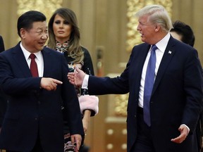 In this Nov. 9, 2017, file photo, U.S. President Donald Trump, China's President Xi Jinping arrive for the state dinner with the first ladies at the Great Hall of the People in Beijing, China.