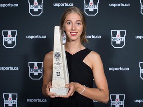 Montreal Carabins volleyball player Marie-Alex Belanger, of Joliette, Que., poses for a photograph with the trophy after being named female U Sports Athlete of the Year for the 2017-18 season, in Vancouver, on Monday June 4, 2018.