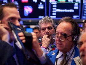 Traders watch the market reaction to tariff developments at the New York Stock Exchange.