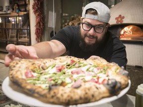 Erik Mandracchia with a Cotto pizza at restaurant Fiorellino May 31, 2018.