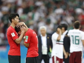 South Korea's Son Heung-min, left, consoles teammate Hwang Hee-chan at the end of the group F match between Mexico and South Korea at the 2018 soccer World Cup in the Rostov Arena in Rostov-on-Don, Russia on Saturday, June 23, 2018. Mexico won 2-1.