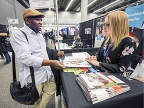 Ali Diaoune, from Guinea, speaks with Jessica Campeau from L'Orientheque, a workforce integration organization representing the Sorel-Tracy region.