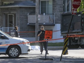 Montreal police officers at the scene of a fatal bike accident at St-Zotique St. and 19th Ave. on Monday, June 11, 2018. The Montreal Bike Coalition has said in a statement that no action had yet been taken to make the location safer.