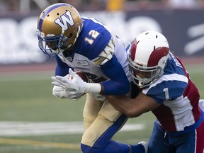 Montreal Alouettes' Branden Dozier brings down Winnipeg Blue Bombers' Adarius Bowman at Molson Stadium on June 22, 2018. The Alouettes acquired Bowman on Monday for a conditional eighth-round pick in 2019.