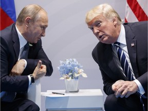 Russian President Vladimir Putin, left, and U.S. President Donald Trump chat during a meeting held July 7, 2017. They are to meet again in Helsinki on July 16.