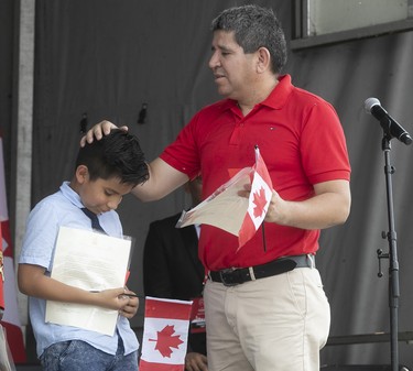 Victor Sotomayor and his son Nicolas after receiving their Canadian citizenship, during swearing in ceremony at the Old Port on Sunday July 1, 2018. (Pierre Obendrauf / MONTREAL GAZETTE)
