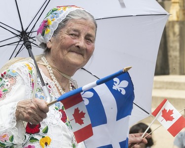 A Hungarian woman participates in the Canada Day parade in downtown Montreal on Sunday July 1, 2018. (Pierre Obendrauf / MONTREAL GAZETTE)