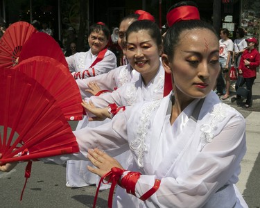 A women takes part in the Canada Day parade in downtown Montreal on Sunday July 1, 2018. (Pierre Obendrauf / MONTREAL GAZETTE)