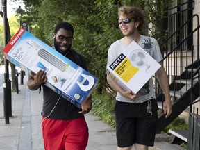 Heat relief: Saed Desire, left, and Gabriel Labrasseur bought fans during heat wave in Montreal last week.