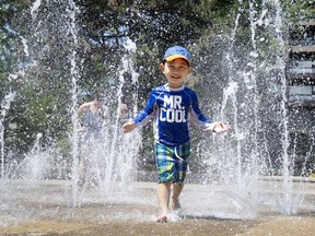 Three-year-old Ain Choi is Mr. Cool as he runs through the fountain in Westmount Park as Montreal endures a heat wave on July 2, 2018.