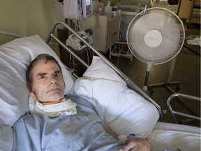 Derek Cobb relies on a fan and damp cloths to keep cool in his non-air conditioned room at Verdun General Hospital in Montreal on July 2, 2018.