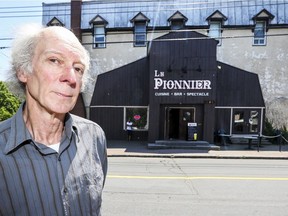 Paul Parfett, a garage owner in Pointe-Claire Village, stands across from the Pioneer bar, which he hopes to buy.