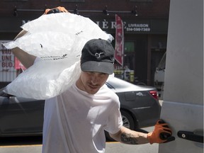 Conrad Pomerleau of Les Marchands loads up his shoulders with bags of ice for a Montreal restaurant.
