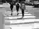 Three boys jump over freshly painted 3D crosswalk markings in the Outremont borough of Montreal on Tuesday, July 10, 2018. 