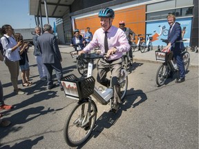 Marc Demers, mayor of Laval, tries out an electric bike on Thursday, July 12, 2018.