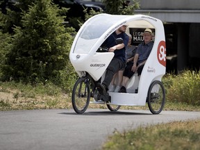 Pedicab driver David Deladurantaye Leblanc drives seniors Jean Caruthers and Rene Lebel in the Saint-Larent borough of Montreal on Friday July 13, 2018.