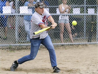 CJAD radio personality Aaron Rand hits the ball during exhibition softball game between local players and Expos Nation at Jeanne Mance Park in Montreal Saturday July 14, 2018.  The event was held in response to the Plateau Mont-Royal's decision to close the north softball field in the same park.  Rand was playing for Expos Nation.  (John Mahoney / MONTREAL GAZETTE) ORG XMIT: 61056 - 0539