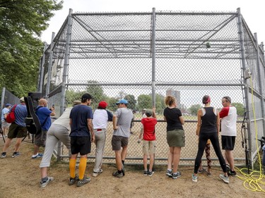 Spectators line the backstop during exhibition softball game between local players and Expos Nation at Jeanne Mance Park in Montreal Saturday July 14, 2018.  The event was held in response to the Plateau Mont-Royal's decision to close the north softball field in the same park.  (John Mahoney / MONTREAL GAZETTE) ORG XMIT: 61056 - 2083