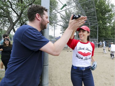 Joey Berger high-fives Marisa Berry Mendez after she scored a run during exhibition softball game between local players and Expos Nation at Jeanne Mance Park in Montreal Saturday July 14, 2018.  The event was held in response to the Plateau Mont-Royal's decision to close the north softball field in the same park.  (John Mahoney / MONTREAL GAZETTE) ORG XMIT: 61056 - 2172