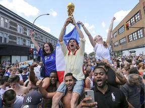 French football fans pack the intersection of St-Denis and Rachel Sts. in Montreal Sunday July 15, 2018 following France's World Cup victory over Croatia. (John Mahoney / MONTREAL GAZETTE)
