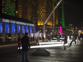 Montrealers enjoy illuminated see-saws at an installation called Impulse at Place des Spectacles in December 2015.