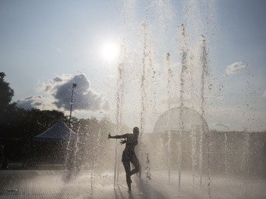 A woman cools down during the Heavy Montreal Festival in Montreal, July 28, 2018.