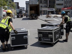 Workers cart away equipment that had been set up for the 36th Just for Laughs in Montreal. The festival, which ended Sunday, lured some of the biggest names in the comedy universe, Bill Brownstein says.
