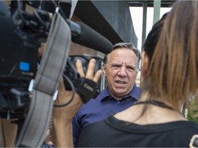 CAQ leader François Legault speaks to the press after a walk through the Marché de L’Ouest in Dollard-des-Ormeaux on Saturday.