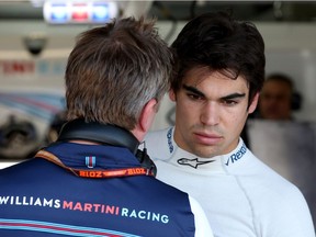 Lance Stroll consults with a team member in the Williams garage during Friday practice for the German Grand Prix in Hockenheim.