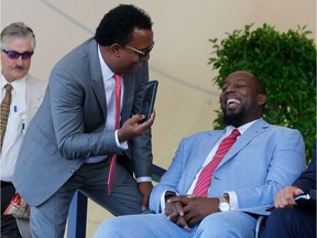 Hall of Famer Pedro Martinez has a laugh with 2018 inductee Vladimir Guerrero at Clark Sports Center during the Baseball Hall of Fame induction ceremony on July 29, 2018 in Cooperstown, New York.