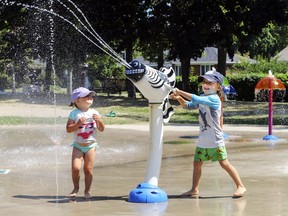 Two-year-old Mila McConnell watches as her brother Étienne mans the water canon at the splash pad at Pine Beach Park in Dorval. It's important to give our children a reprieve from their highly structured lives and let them play by their own rules.