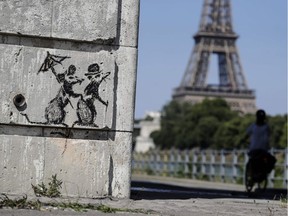 A recent artwork by street artist Banksy in Paris on June 27, 2018, near the Eiffel Tower.