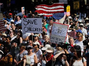 TOPSHOT - Demonstrators march against the separation of immigrant families, on June 30, 2018 in New York. Demonstrations are being held across the US Saturday against President Donald Trump's hardline immigration policy.