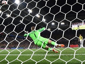 Colombia's midfielder Mateus Uribe (R) misses to score a penalty kick as England's goalkeeper Jordan Pickford (C) jumps to catch the ball during the penalty shoot-out of the Russia 2018 World Cup round of 16 football match between Colombia and England at the Spartak Stadium in Moscow on July 3, 2018.