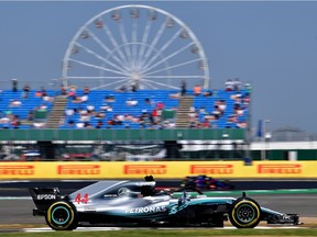 Lewis Hamilton steers his Mercedes during Friday practice for his home British Grand Prix. He was fastest in the morning session but dropped behind Ferrari rival Sebastian Vettel in the afternoon.