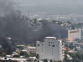 Smoke from Oasis hotel where cars were burned in the hotel's parking lot, after protesters set them on fire during protests against the rising price of fuel, on July 7, 2018. Haiti's Prime Minister Jack Guy Lafontant on Saturday announced the suspension "until further notice" of an unpopular fuel price hike that had triggered a wave of violent protests across the Caribbean nation. Just before the declaration, the leader of Haiti's lower house of parliament had threatened a government takeover if the fuel price increases were not reversed.