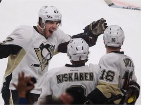 Pittsburgh Penguins defenceman Simon Després, left, and teammates Matt Niskanen celebrate a goal by Brandon Sutter, right, against Montreal Canadiens goalie Carey Price the Bell Centre in Montreal on March 2, 2013.