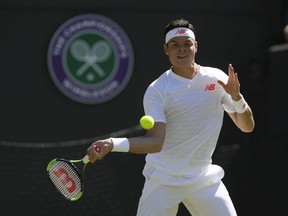 Milos Raonic of Canada returns a ball to Liam Broady of Britain during the Men's Singles first round match at the Wimbledon Tennis Championships in London, Monday July 2, 2018.