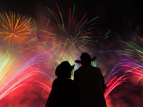 A couple watches the fireworks at the end of the Calgary Stampede grandstand show on Monday July 9, 2018. Gavin Young/Postmedia