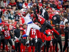 Alouettes' Ernest Jackson, left, goes up for a pass as Stampeders' Jamar Wall, defends during first quarter CFL football action in Calgary on Saturday, July 21, 2018.
