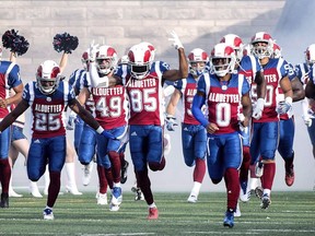 Montreal Alouettes players run onto the field prior to their season home opening CFL football game against the Winnipeg Blue Bombers in Montreal on June 22, 2018.