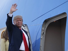 U.S. President Donald Trump waves when boarding Air Force One as he leaves from the airport in Helsinki, Finland, Monday, July 16, 2018, after the meeting with Russian President Vladimir Putin in the Finnish capital.