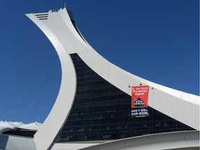 Greenpeace activists hang a banner from Olympic Stadium in Montreal, Thursday, July 19, 2018, protesting Canada's Trans Mountain pipeline expansion.